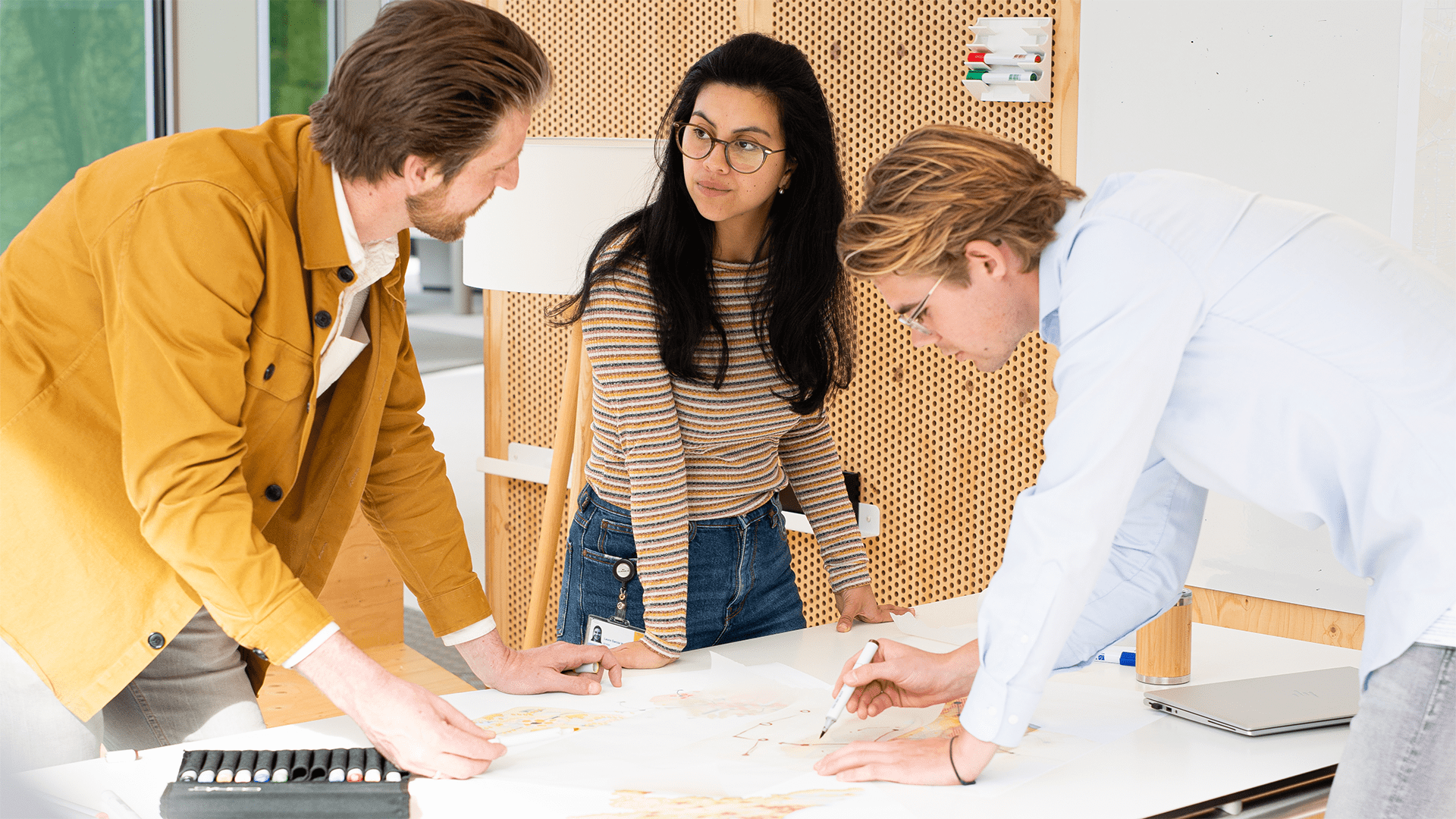 Three colleagues at work trying to solve a task