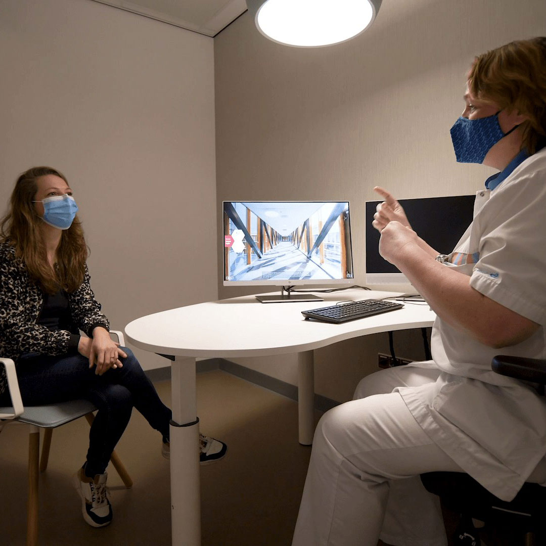 A doctor and a patient wearing face masks