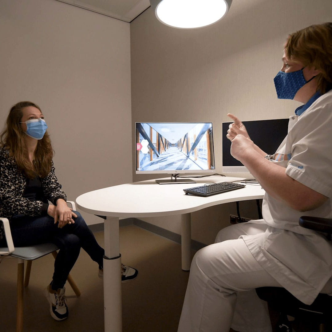 A doctor and a patient wearing face masks