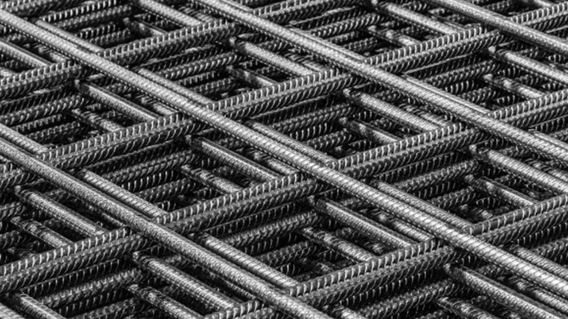 Close-up van een stalen wapeningsnet met kruislings gevlochten ribbelstaven