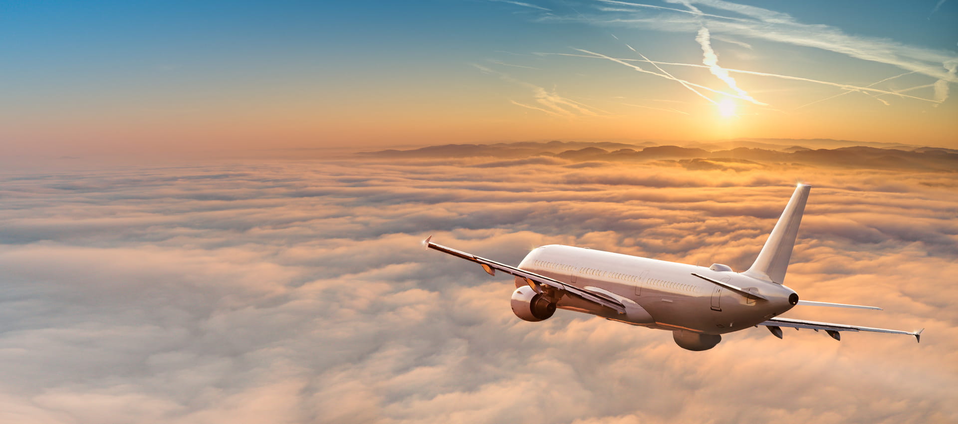 Vliegtuig vliegt boven de wolken, richting de zon